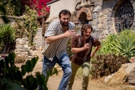Nick Cage (Nicolas Cage) and Javi (Pedro Pascal) run through a villa in The Unbearable Weight of Massive Talent (2022).
