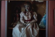 An Annabelle doll sits on a pink shelf in Annabelle (2014).