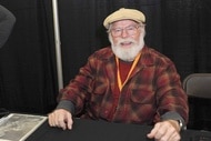 Charles Cyphers smiles in a red flannel.