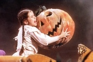 Dorothy (Fairuza Balk) holds a giant smiling pumpkin head in Return to OZ (1985).