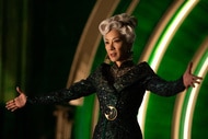 Madame Morrible holds her arms out in Wicked