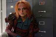 Irisa (Stephanie Leonidas) crouches near cabinets in Defiance Episode 111.