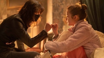 Joey (Melissa Barrera) and Abigail (Alisha Weir) pinky promise in Abigail (2024).