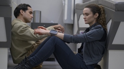 Ian (Reece Ritchie) and Lt. Sharon Garnet (Christie Burke) sit next to each other on the floor on The Ark Episode 209.