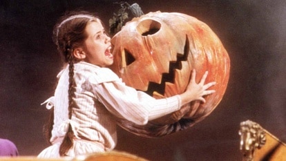 Dorothy (Fairuza Balk) holds a giant smiling pumpkin head in Return to OZ (1985).