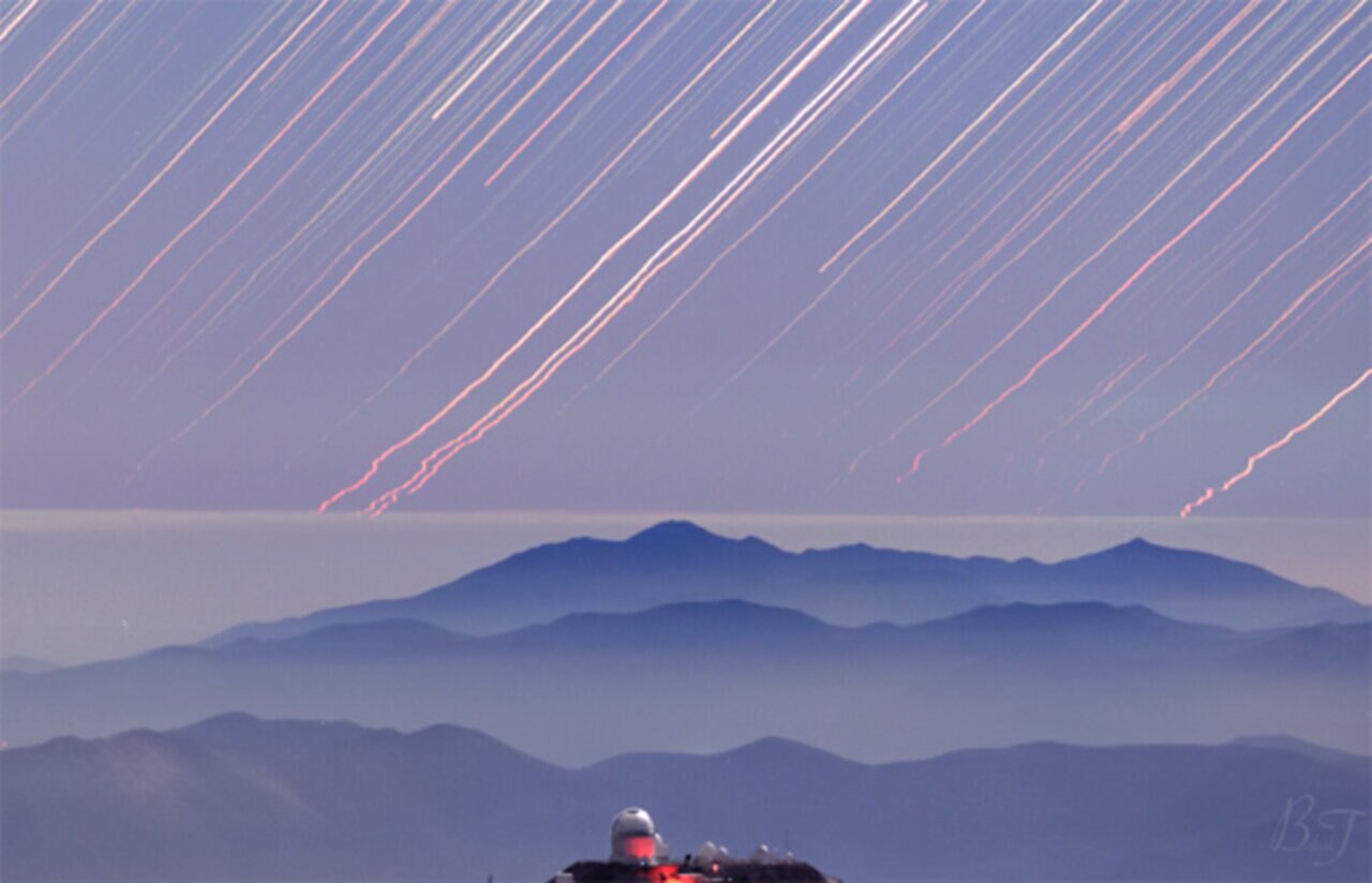 Rocket trails move sideways through the sky