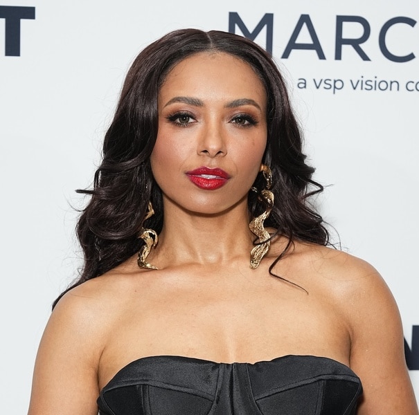 Kat Graham wears a black strapless dress.