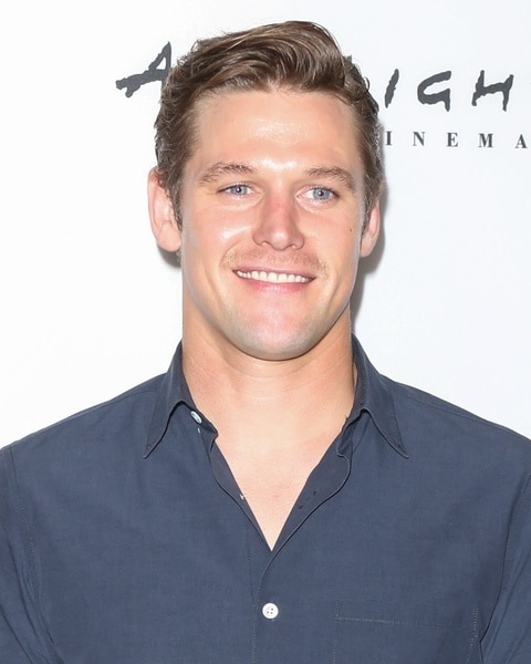 Zach Roerig smiles in a grey shirt.