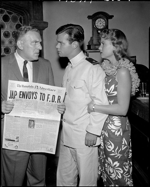 Peter Jenson (William Bendix) holds a newspaper while arguing with Janoski (Darryl Hickman) and Mrs. Janoski (Caroline Kearney) on Westinghouse Desilu Playhouse.