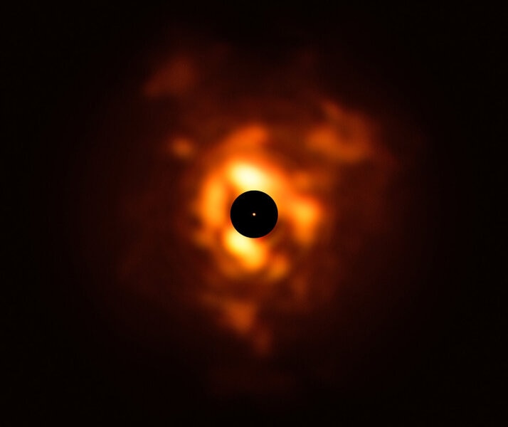 An image of the star Betelgeuse taken in infrared shows it’s surrounded by a vast cloud of dust that erupted from the surface (the bright star itself is masked out, though an image of it has been superposed there for scale — it’s about the size of the orb