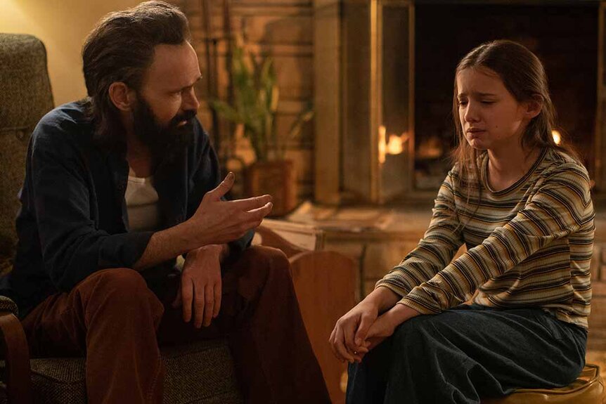 (from left) Terrence Shaw (Jeremy Davies) sits and talks to Gwen Shaw (Madeleine McGraw) who is crying in The Black Phone (2022).