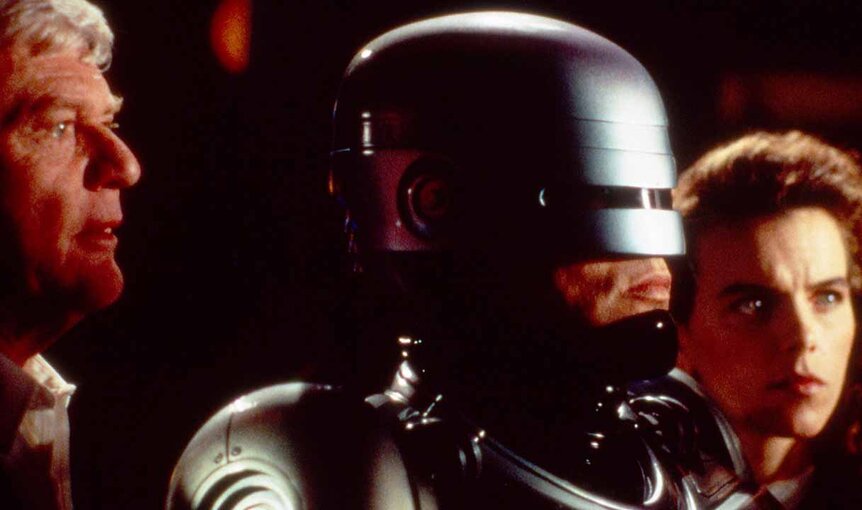 Robocop (Richard Eden) stands between Russell Murphy (Martin Milner) and Detective Lisa Madigan (Yvette Nipar) in Robocop: The Series.