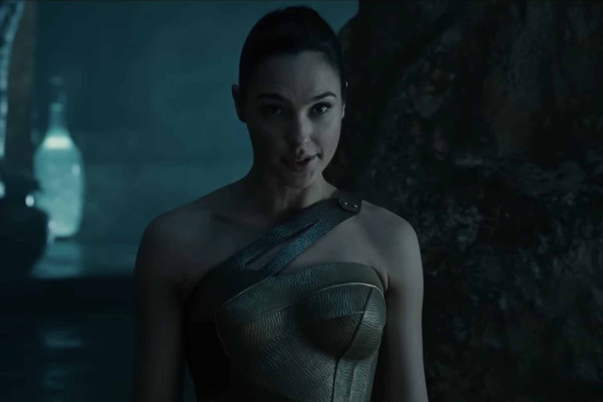 Wonder Woman (Gal Gadot) stands in a cave in Wonder Woman (2017).