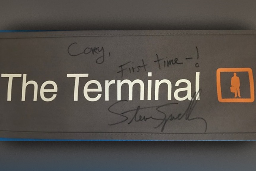 A signed The Terminal (2004) placard from Steven Spielberg to Corey Reynolds that says "Corey- First time!".