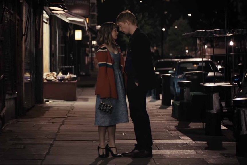 Mary (Rachel McAdams) and Tim Lake (Domhnall Gleeson) approach a kiss on a sidewalk Iin About Time (2013).