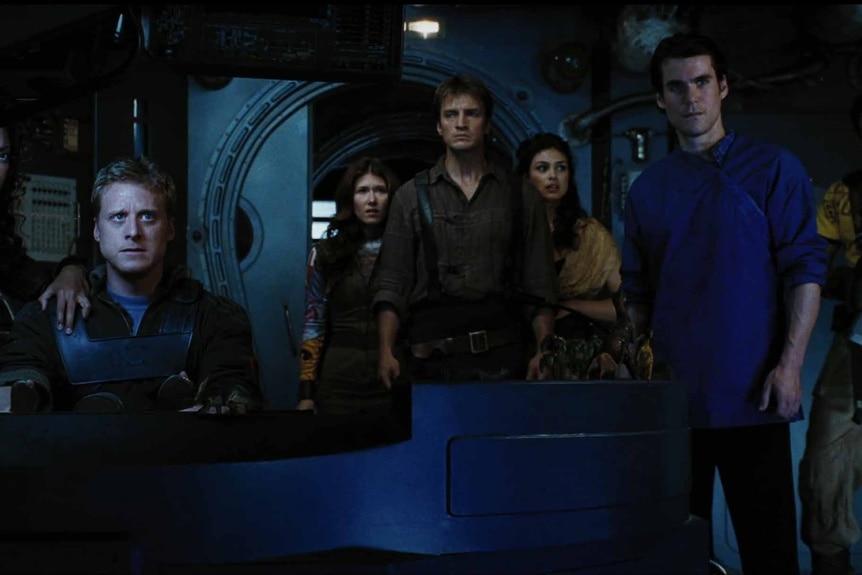 The crew of the Serenity stands in Serenity (2005).