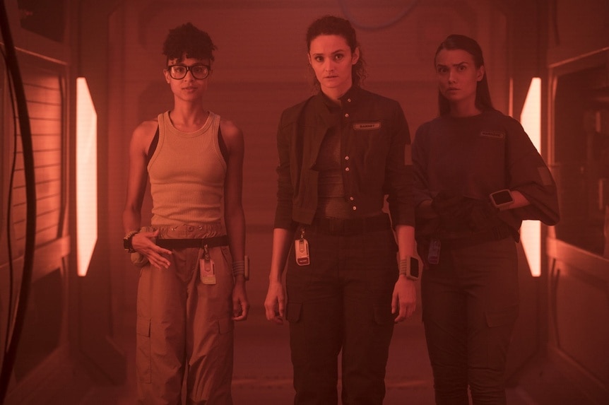 Alicia Nevins (Stacey Read), Lt. Sharon Garnet (Christie Burke), and Eva Markovic (Tiana Upcheva) walk through a hallway on The Ark Episode 203.