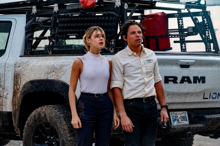 Kate and Javi stare up at the sky in Twisters