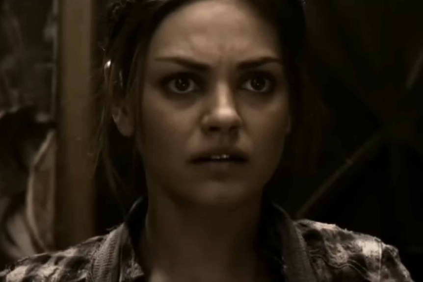 Solara (Mila Kunis) appears concerned in The Book of Eli (2010).