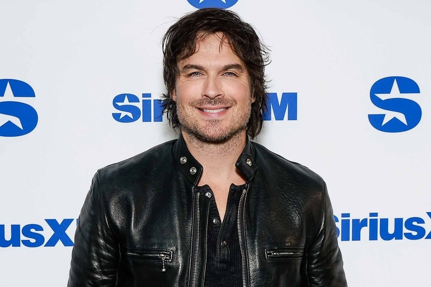 Ian Somerhalder smiles in a leather jacket.