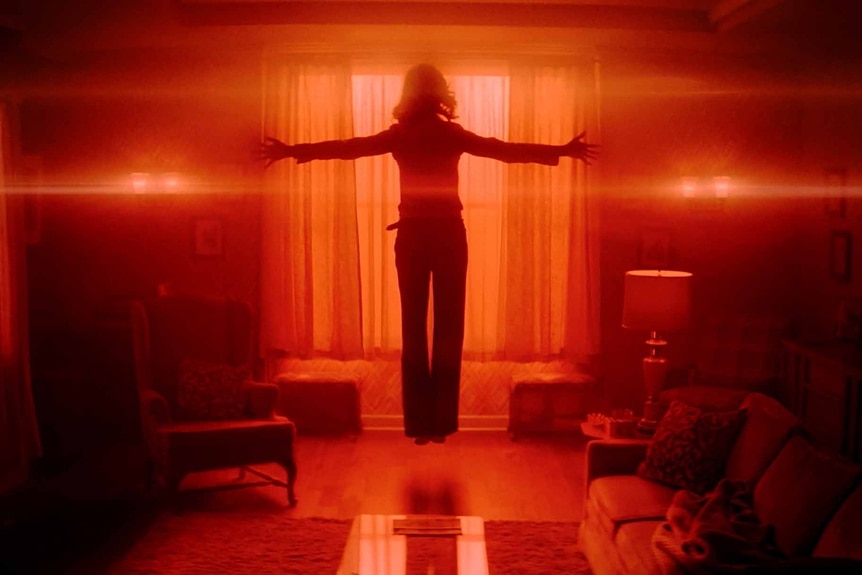 Linda (Julie Bowen) levitates in a glowing red room on Hysteria! Episode 101.