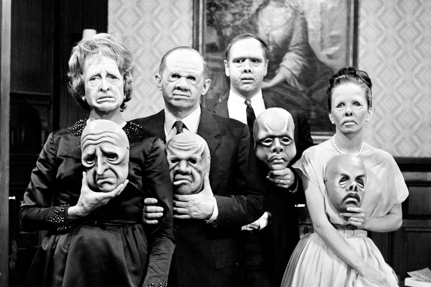 The cast of The Twilight Zone holds scary masks in Episode 525.