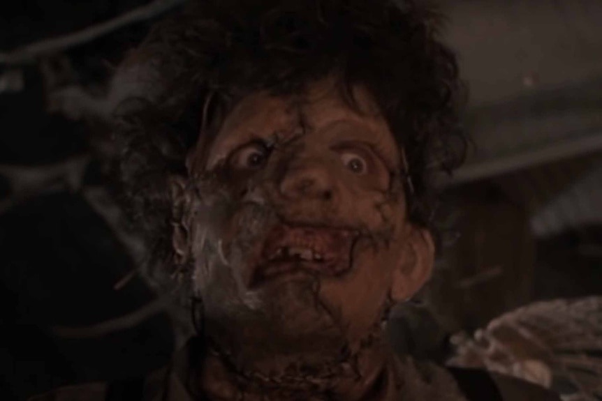 Leatherface (Bill Johnson) has a disfigured face in The Texas Chainsaw Massacre 2 (1986).