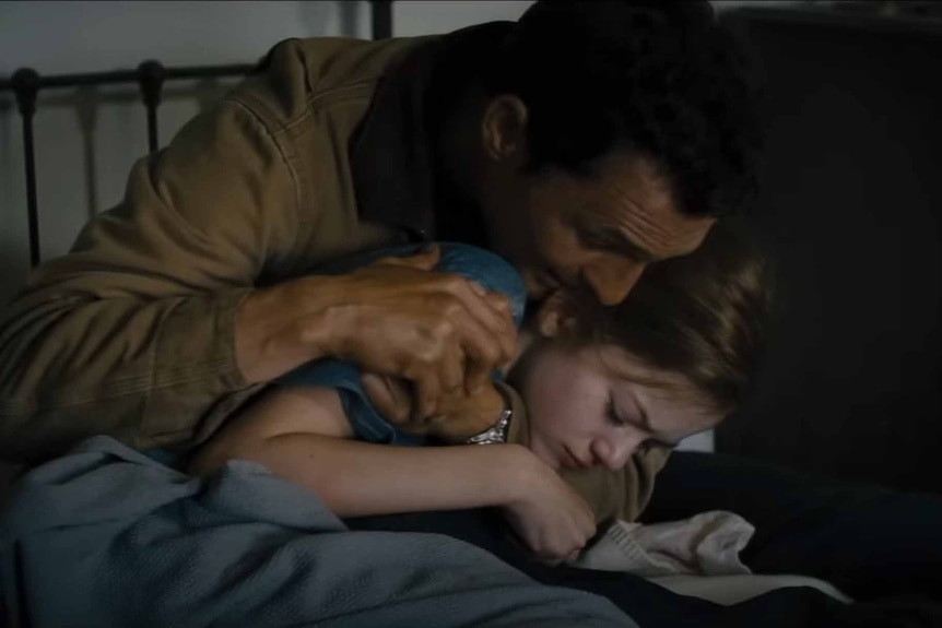 Cooper (Matthew McConaughey) hugs his daughter Murph (Mackenzie Foy) in Interstellar (2014).