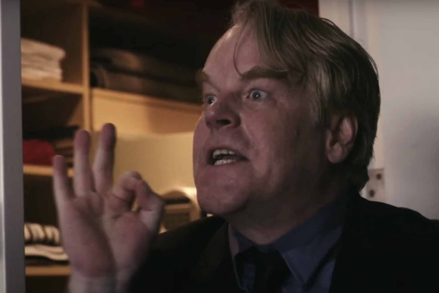 Andy (Philip Seymour Hoffman) argues with his hands in Before the Devil Knows You're Dead (2007).