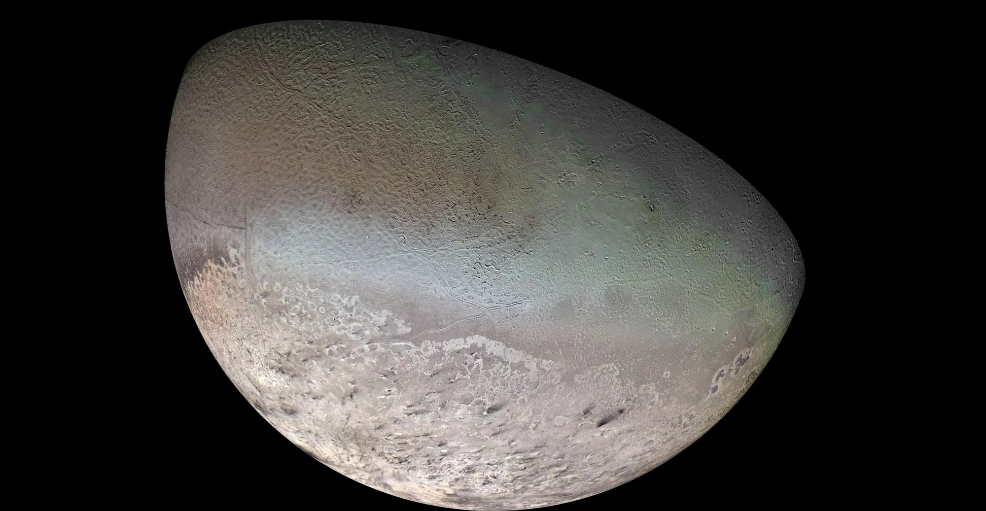 A mosaic of Neptune’s moon Triton created from Voyager 2 images during a flyby in 1989. Note the black streaks near the bottom; evidence of geyser-like eruptions and wind. Credit: NASA/JPL/USGS